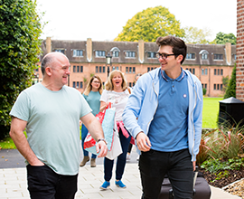 Dad and son walking through campus on arrivals day